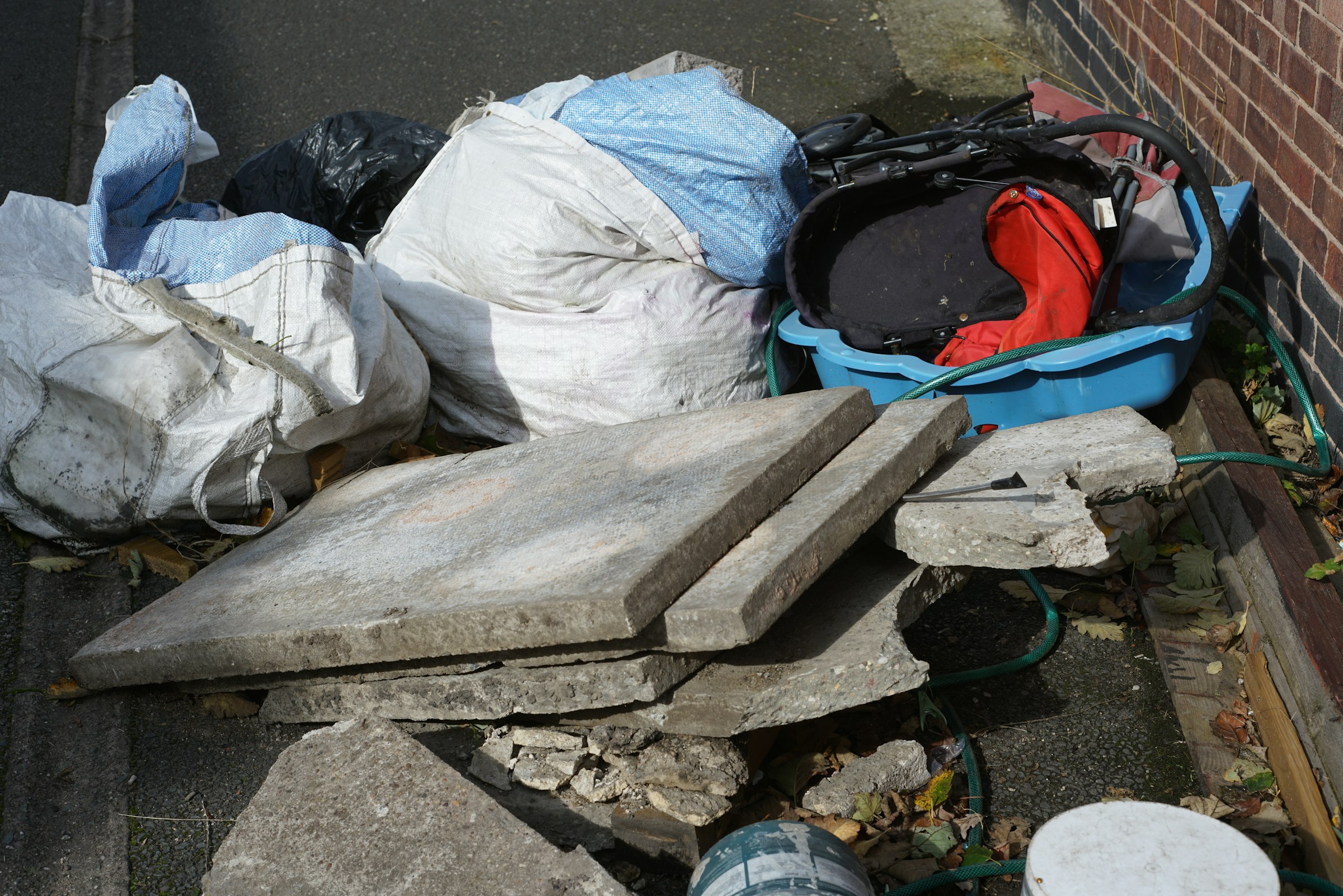 Pile of rubbish bags and concrete slabs