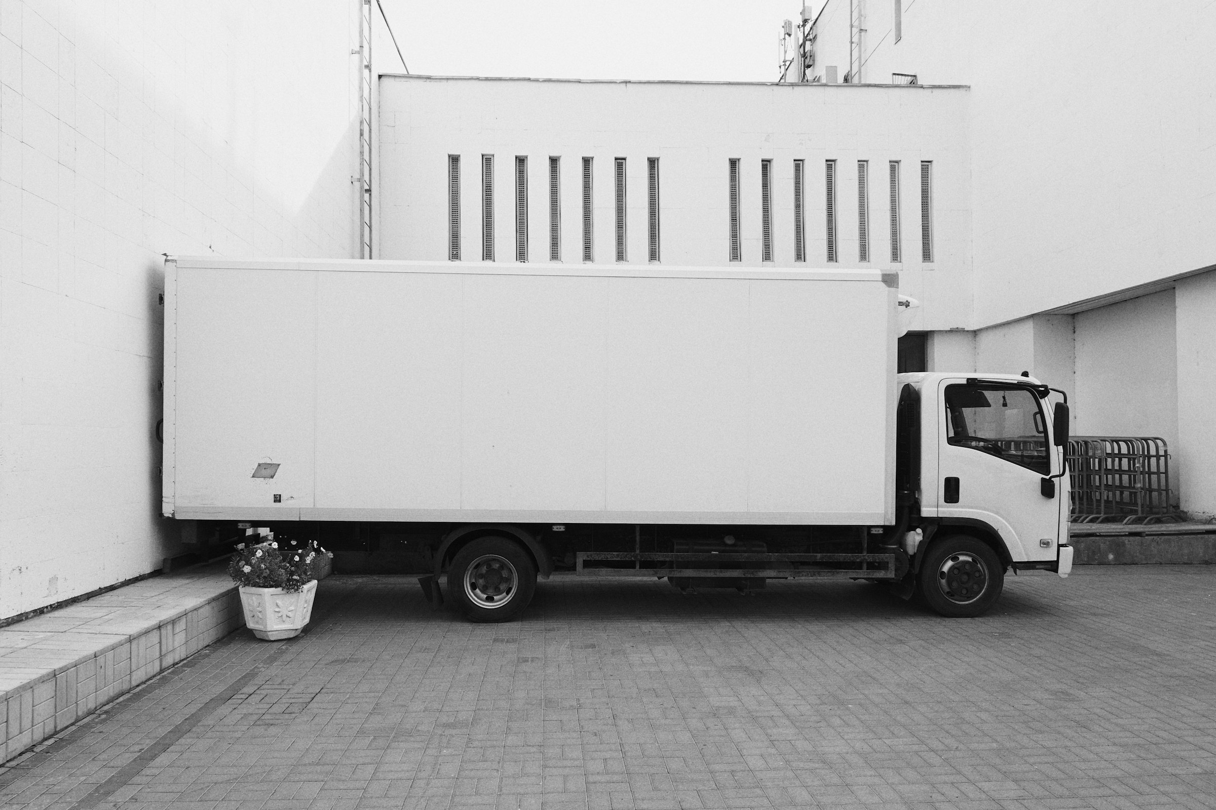 White truck parked near a white building